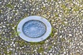 Recessed lighting in a gravel floor of a pedestrian walkway with water condensation against the glass Royalty Free Stock Photo