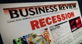 Recession and business crisis newspaper on mobile tablet screen Royalty Free Stock Photo