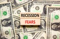 Recession fears symbol. Concept words Recession fears on wooden blocks on a beautiful background from dollar bills. Business and