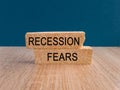 Recession fears symbol. Concept words Recession fears on wooden blocks on a beautiful dark blue background