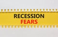 Recession fears symbol. Concept words Recession fears on yellow paper on a beautiful white background. Business and recession