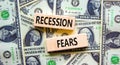 Recession fears symbol. Concept words Recession fears on wooden blocks on a beautiful background from dollar bills. Business and