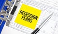 Recession fears words on paper notebook with pen Royalty Free Stock Photo