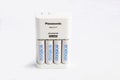 Recharcheable AA batteries with charger on white background