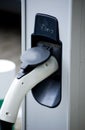 Recharging electric car by power cable. Royalty Free Stock Photo