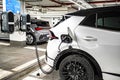 Recharging electric cars at the charging station in the underground parking. The concept of ecological energy systems