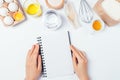 Recipe for baking homemade bread, women's hands holding blank notebook