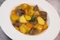 Recipe for beer and mustard beef chuck stew with potatoes, turnips and carrots