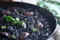 Black rice paella with seafood and fish. Traditional Spanish recipe. Royalty Free Stock Photo