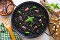 Black rice paella with seafood and fish. Traditional Spanish recipe. Royalty Free Stock Photo