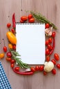 Recipe book with fresh vegetables and herbs on wooden. Royalty Free Stock Photo