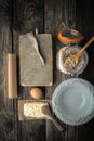 Recipe book, plate and ingredients for cookies on a wooden table