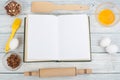 Recipe cook blank book on wooden background, spoon, rolling pin, checkered tablecloth. Top view