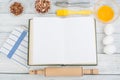 Recipe cook blank book on wooden background, spoon, rolling pin, checkered tablecloth. Top view