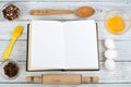 Recipe cook blank book on wooden background, spoon, rolling pin, checkered tablecloth. Top view