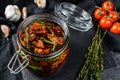 Recipe for cooking dried tomatoes in olive oil with spices and herbs. Black background. Top view Royalty Free Stock Photo