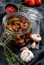 Recipe for cooking dried tomatoes in olive oil with spices and herbs. Black background. Top view Royalty Free Stock Photo