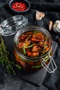 Recipe for cooking dried tomatoes in olive oil with spices and herbs. Black background. Top view Royalty Free Stock Photo