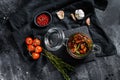 Recipe for cooking dried tomatoes in olive oil with spices and herbs. Black background. Top view Royalty Free Stock Photo