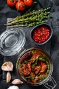 Recipe for cooking dried tomatoes in olive oil with spices and herbs. Black background. Top view Royalty Free Stock Photo