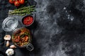 Recipe for cooking dried tomatoes in olive oil with spices and herbs. Black background. Top view. Copy space Royalty Free Stock Photo