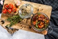 Recipe for cooking dried tomatoes in olive oil with spices and herbs. Gray background. Top view Royalty Free Stock Photo