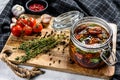 Recipe for cooking dried tomatoes in olive oil with spices and herbs. Gray background. Top view Royalty Free Stock Photo