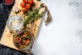 Recipe for cooking dried tomatoes in olive oil with spices and herbs. Gray background. Top view. Copy space Royalty Free Stock Photo