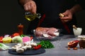 Recipe for cooking rabbit meat. Chef pouring oil on rabbit meat, cooking process, restaurant concept