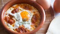 Egg cooked in the oven with sobrassada. Traditional Spanish tapa.