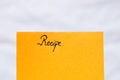 Recipe handwriting text close up isolated on orange paper with copy space