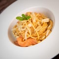 Recipe for homemade spaghetti with tomato sauce, smoked salmon, roasted peanuts and parmesan