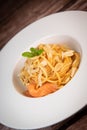 Recipe for homemade spaghetti with tomato sauce, smoked salmon, roasted peanuts and parmesan