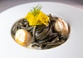 Recipe for Linguine Pasta with squid ink and scallops, yellow chioggia beet Royalty Free Stock Photo