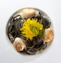 Recipe for Linguine Pasta with squid ink and scallops, yellow chioggia beet Royalty Free Stock Photo