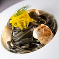 Recipe for Linguine Pasta with squid ink and scallops, yellow chioggia beet Royalty Free Stock Photo