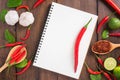 Recipe notebook, Red chilli, garlic and lemon on wooden backgro