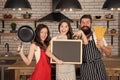 Recipe of perfect family dinner. Mother and father with little girl holding chalkboard copy space. Little girl with