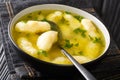 Recipe for Soup with Semolina Dumplings close-up in a plate. horizontal