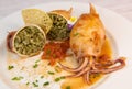 RECIPE FOR STUFFED SQUID, RIZOTTO AND SPINACH PESTO, HOMEMADE TOMATO SAUCE Royalty Free Stock Photo