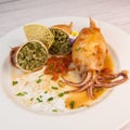 RECIPE FOR STUFFED SQUID, RIZOTTO AND SPINACH PESTO, HOMEMADE TOMATO SAUCE Royalty Free Stock Photo