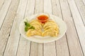 Recipe of traditional Chinese kuo tie dumplings cooked on the grill accompanied by sweet and sour sauce to dip