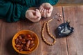 Recitations in the hands of Muslim women at the table before the start of the Ramadan fast