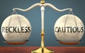 Reckless and cautious staying in balance - pictured as a metal scale with weights and labels reckless and cautious to symbolize
