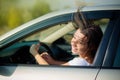 A reckless girl drives a car with her eyes closed Royalty Free Stock Photo