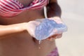 Reckless woman holding a jellyfish