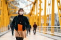 A reckless young Woman walk on crowded street with a mask in a quarantine period because of pandemic global danger.