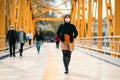 A reckless young Woman walk on crowded street with a mask in a quarantine period because of pandemic global danger.