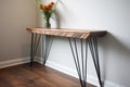 reclaimed wood console table with metal legs in a hallway