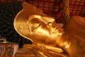 Reclining Buddha gold statue face in Thai temple - Lampang Province , THAILAND. Royalty Free Stock Photo